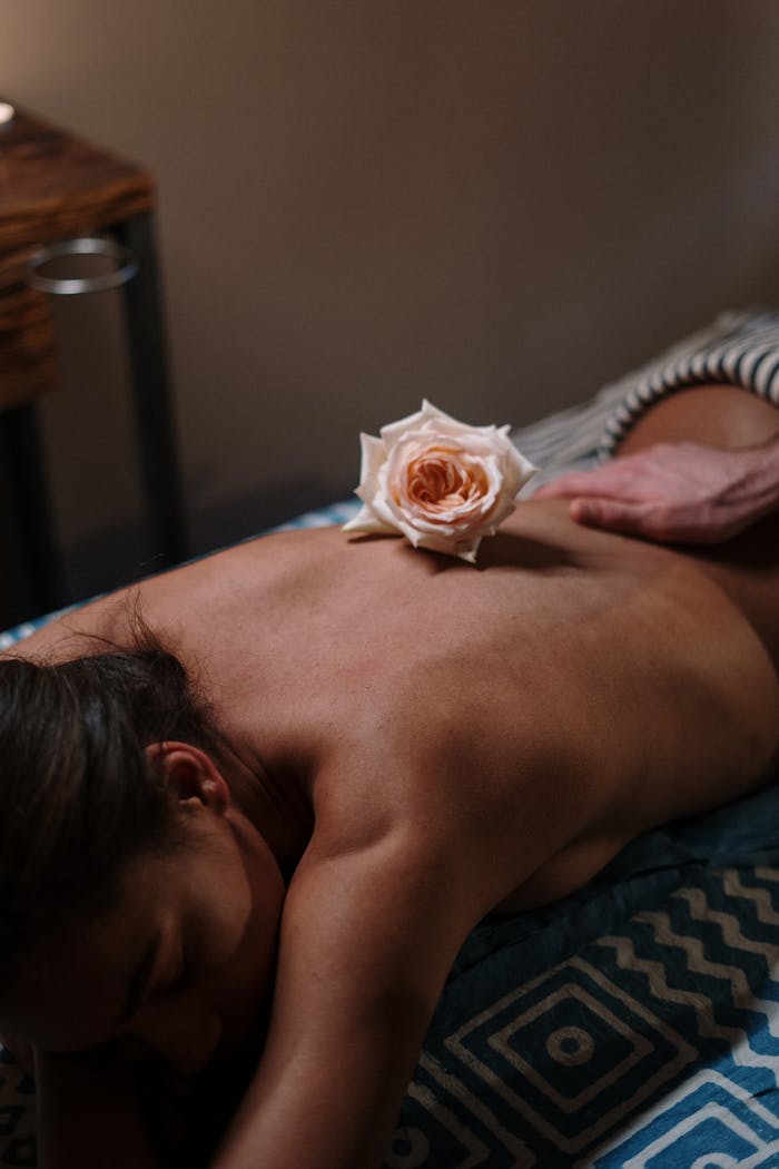 our-experience Soothing spa experience featuring a delicate rose on a woman's back promotes relaxation and wellness.