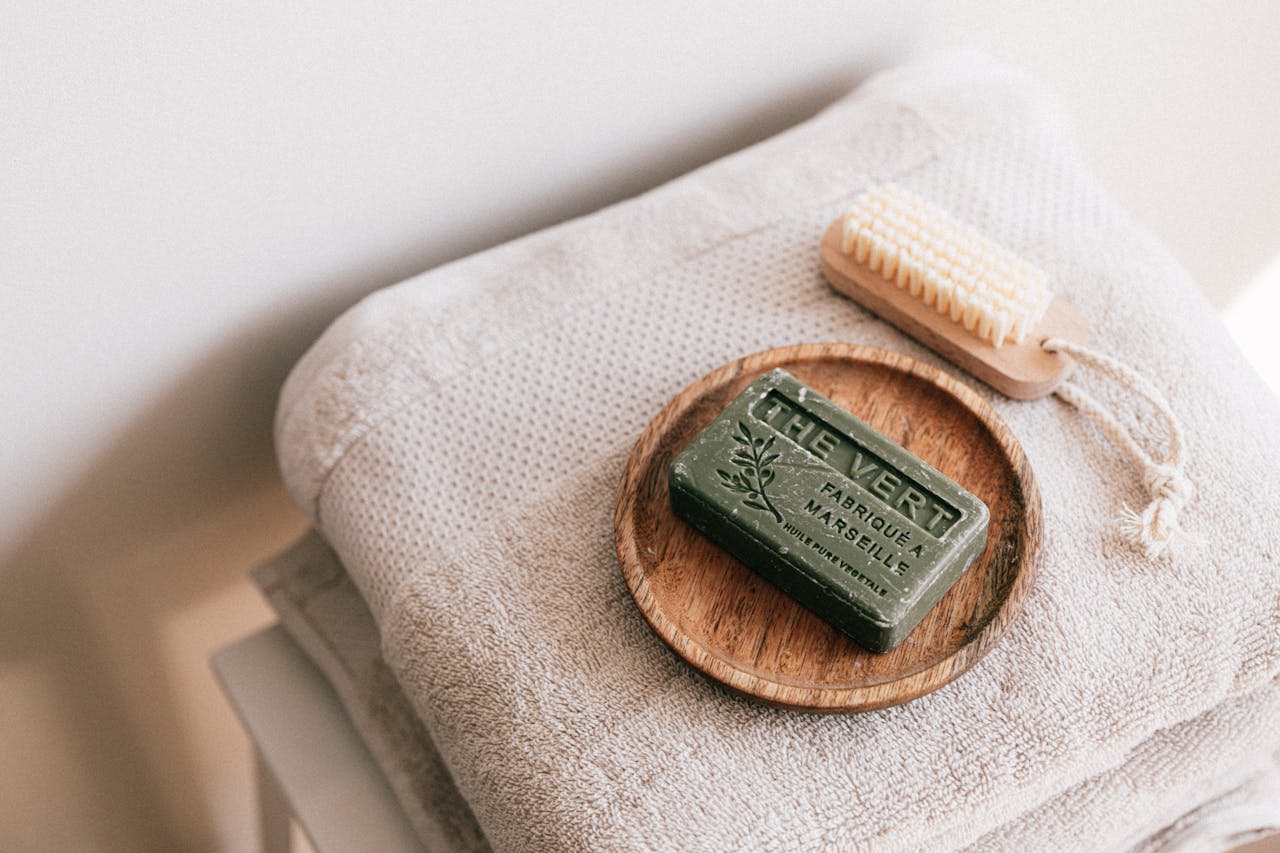 our-services-1 A calming spa scene featuring eco-friendly soap and neatly folded towels, evoking relaxation.